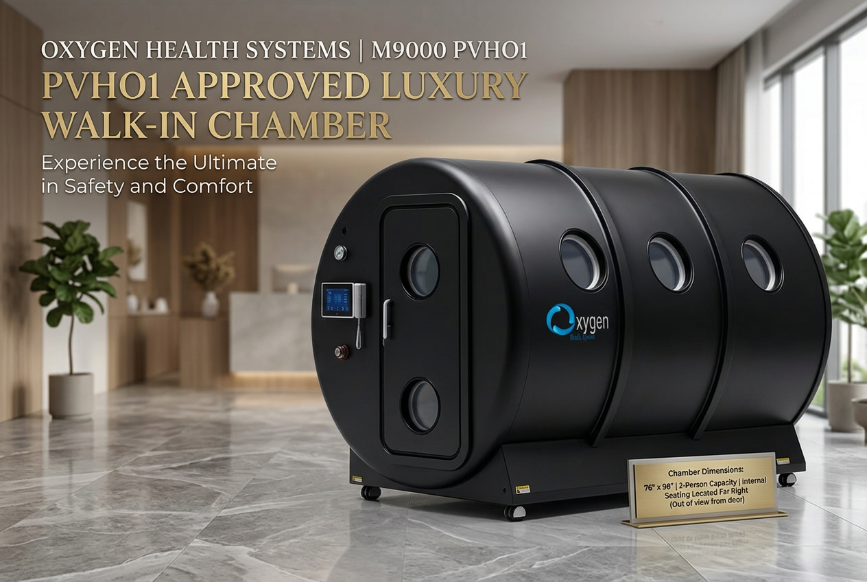 M9000 PVHO1 matte black hard-shell multiplace hyperbaric oxygen chamber in a marble-floored luxury lobby, with Oxygen Health Systems PVHO1 Approved Luxury Walk-in Chamber headline and a gold plaque listing 76 by 98 inch, 2-person capacity
